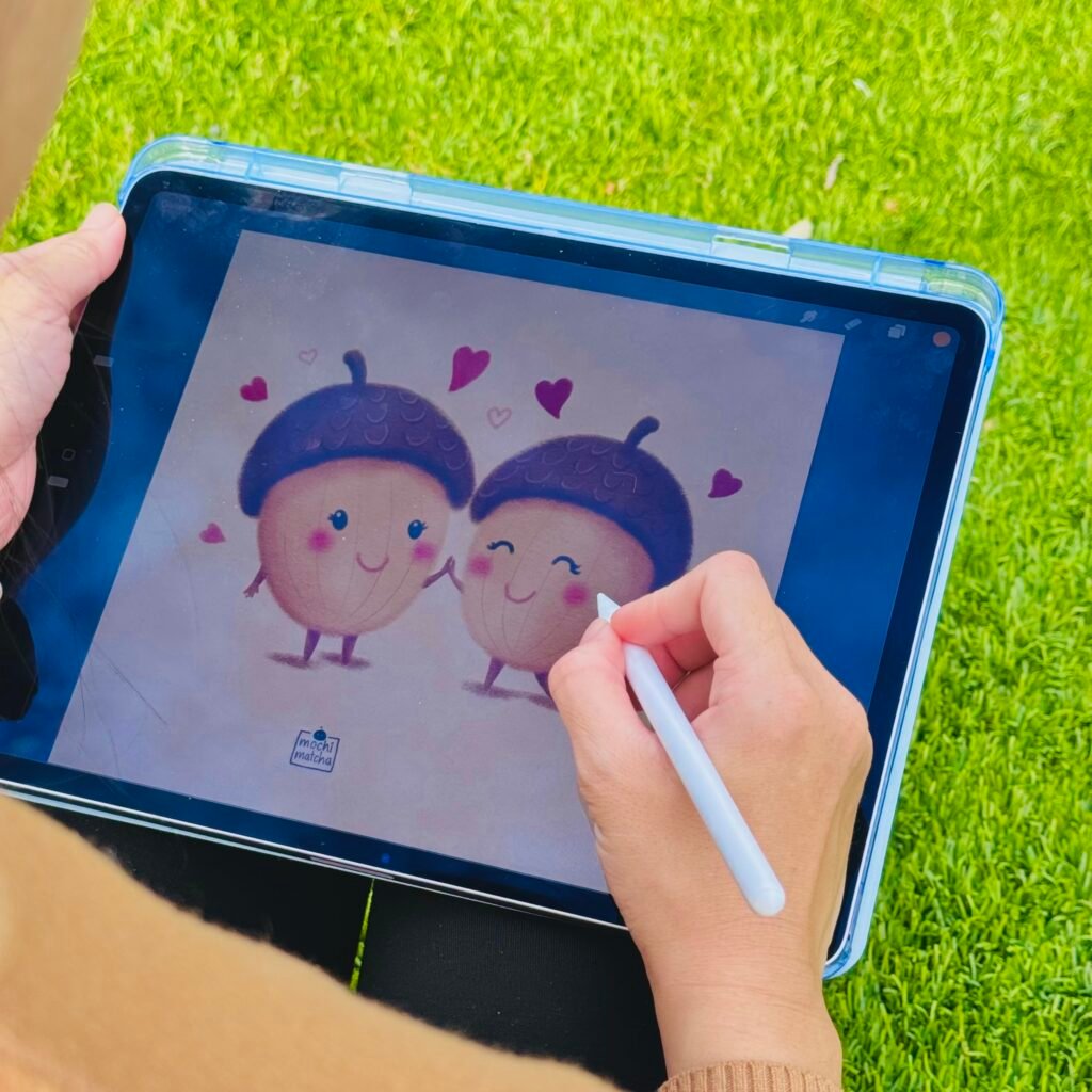 photo-6 An artist drawing two cute acorns on an iPad.